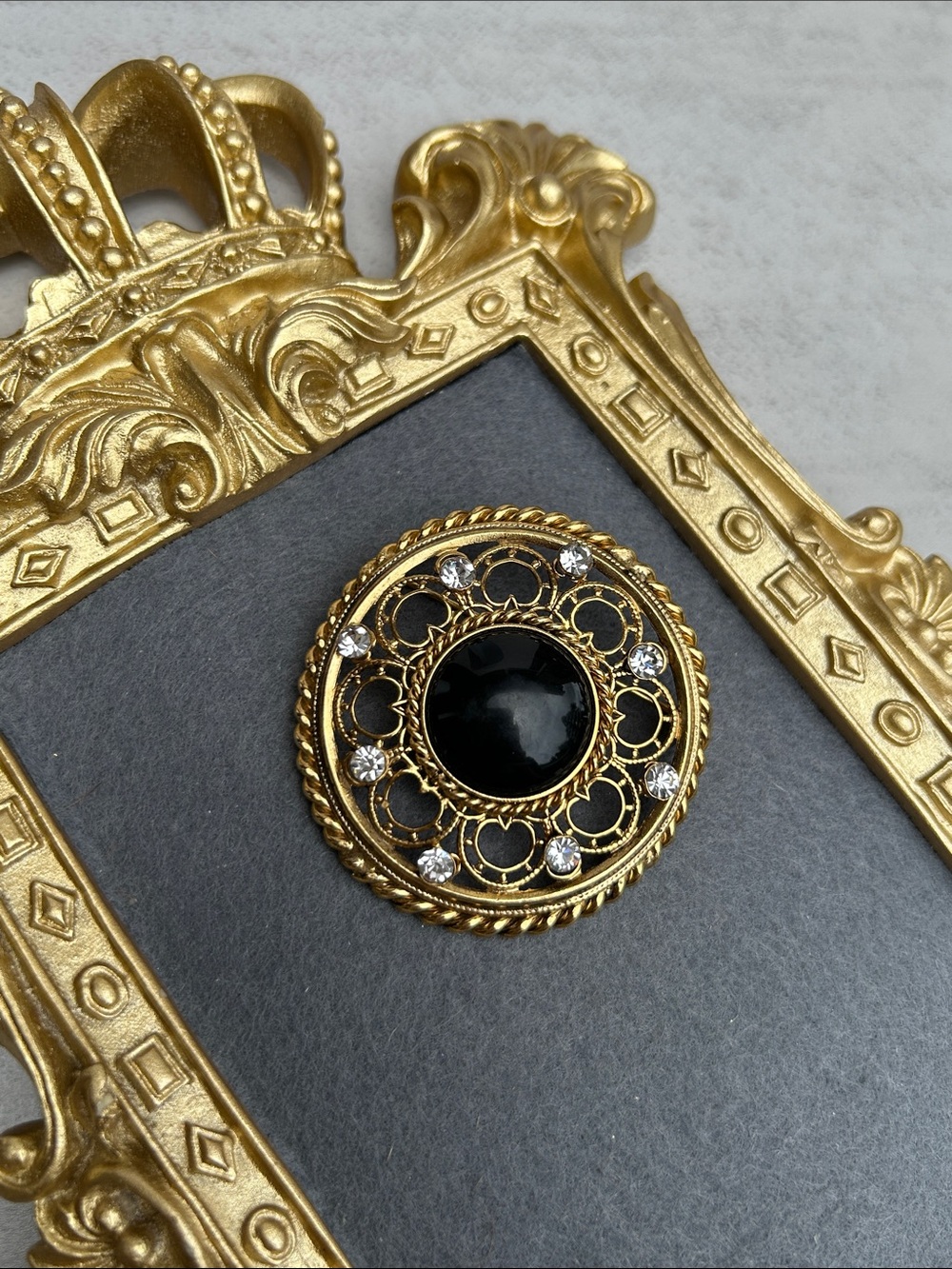 Vintage-Inspired Gold Brooch with Black Center and Rhinestones
